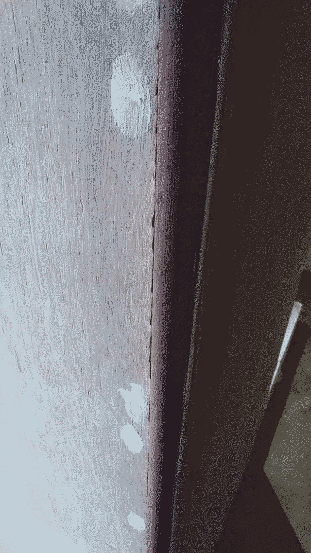 Close up of a strip of jarrah on the corner of the bathroom walls.