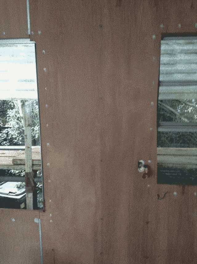 a detail shot of the ply lining the middle of the caravan. lower right a hole with wires stands in for an eventual plug.